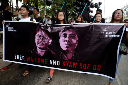 People march to show solidarity for jailed Reuters journalists Wa Lone and Kyaw Soe Oo two days before a local court is due to deliver verdict against them on charges of breaching the country's Official Secrets Act in Yangon, Myanmar, September 1, 2018. REUTERS/Ann Wang/Files