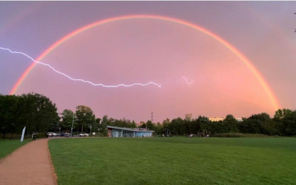 Lightning striking in front of a rainbow at Houghton Hall Park near Dunstable in Bedfordshire - Izzy Brett/PA