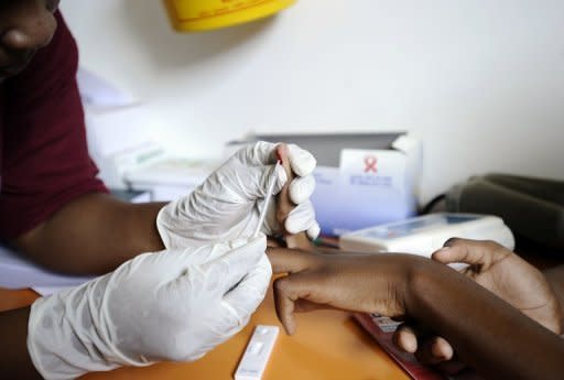 A nurse takes a blood sample in a mobile clinic set up to test students for HIV at Madwaleni high school near Mtubatuba in Kwazulu Natal, South Africa, March 2011. South Africa, home to the highest number of HIV cases in the world, should see a massive reduction by the end of the decade after a sea-change in government policy, a UNAIDS official said Thursday