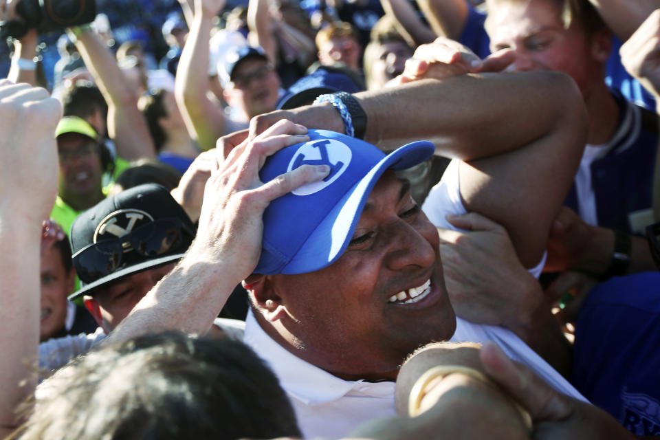 BYU head coach Kalani Sitake celebrates with fans on the field after defeating Southern California on an interception in overtime of an NCAA college football game, Saturday, Sept. 14, 2019, in Provo, Utah. (AP Photo/George Frey)