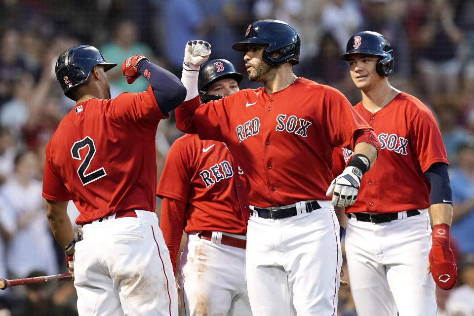 Boston Red Sox's J.D. Martinez celebrates with Xander Bogaerts (2) after hitting a three-run home run during the second inning of the team's baseball game against the Philadelphia Phillies at Fenway Park, Friday, July 9, 2021, in Boston. (AP Photo/Elise Amendola)
