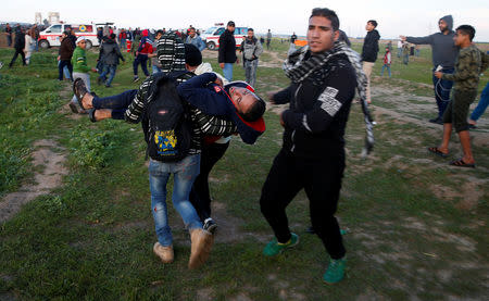 A wounded Palestinian is evacuated during a protest at the Israel-Gaza border fence, east of Gaza City February 22, 2019. REUTERS/Mohammed Salem