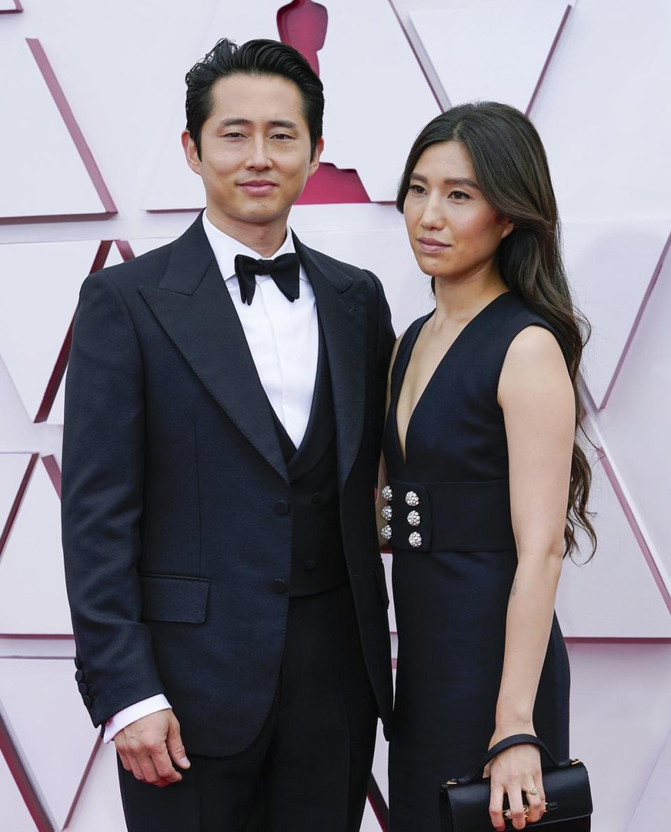 steven yeun and wife joana pak pose for a photo on the oscar red carpet