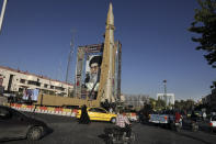 A Shahab-3 surface-to-surface missile is on display next to a portrait of Iranian Supreme Leader Ayatollah Ali Khamenei at an exhibition by Iran's army and paramilitary Revolutionary Guard celebrating "Sacred Defense Week" marking the 39th anniversary of the start of 1980-88 Iran-Iraq war, at Baharestan Sq. in downtown Tehran, Iran, Wednesday, Sept. 25, 2019. Iran's defense minister Wednesday rejected the idea of a deal with world powers over the country's missile program. (AP Photo/Vahid Salemi)