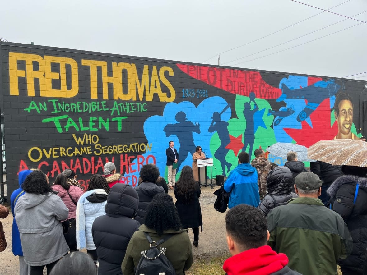 Irene Moore Davis, president, Essex County Black Historical Research Society and Liberal MP Irek Kusmierczyk unveiled the three murals to honour the legacy of several residents of the McDougall Street Corridor, a historically Black neighbourhood in Windsor. (Nav Nanwa/CBC News - image credit)