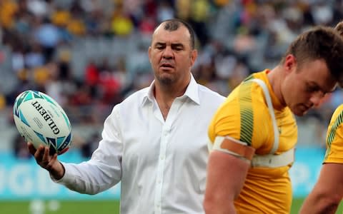 Michael Cheika handles a rugby ball - Credit: AP