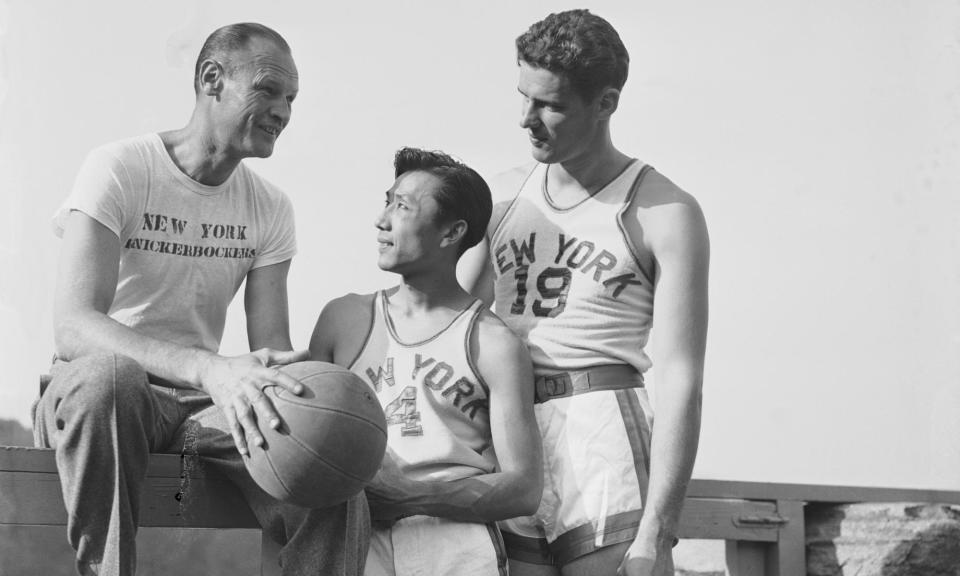 <span>Wat Misaka (center) with his New York Knicks teammates Joe Lapchich and Lee Knorek in 1947. </span><span>Photograph: Bettmann/Bettmann Archive</span>