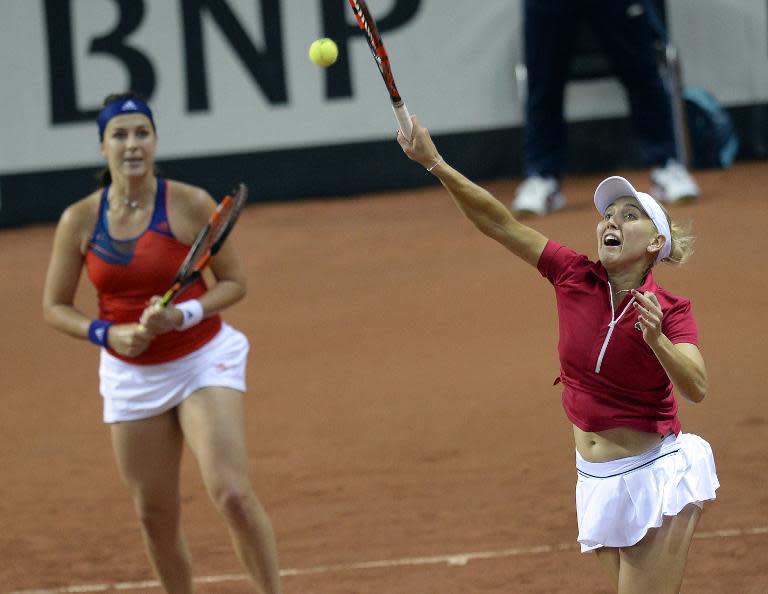 Russia's Anastasia Pavlyuchenkova (L) and Elena Vesnina return a serve to German Andrea Petkovic and Sabine Lisicki during their Fed Cup semi-final against Germany in Sochi on April 19, 2015