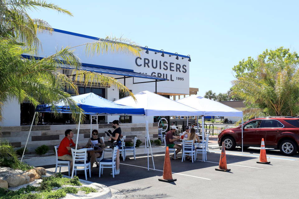 JACKSONVILLE BEACH, FLORIDA - MAY 04: People are seen dining outside at Cruisers Grill as the state of Florida enters phase one of the plan to reopen the state on May 04, 2020 in Jacksonville Beach, Florida. Restaurants, retailers, beaches and some state parks reopen today with caveats, as the state continues to ease restrictions put in place to contain the coronavirus (COVID-19). (Photo by Sam Greenwood/Getty Images)