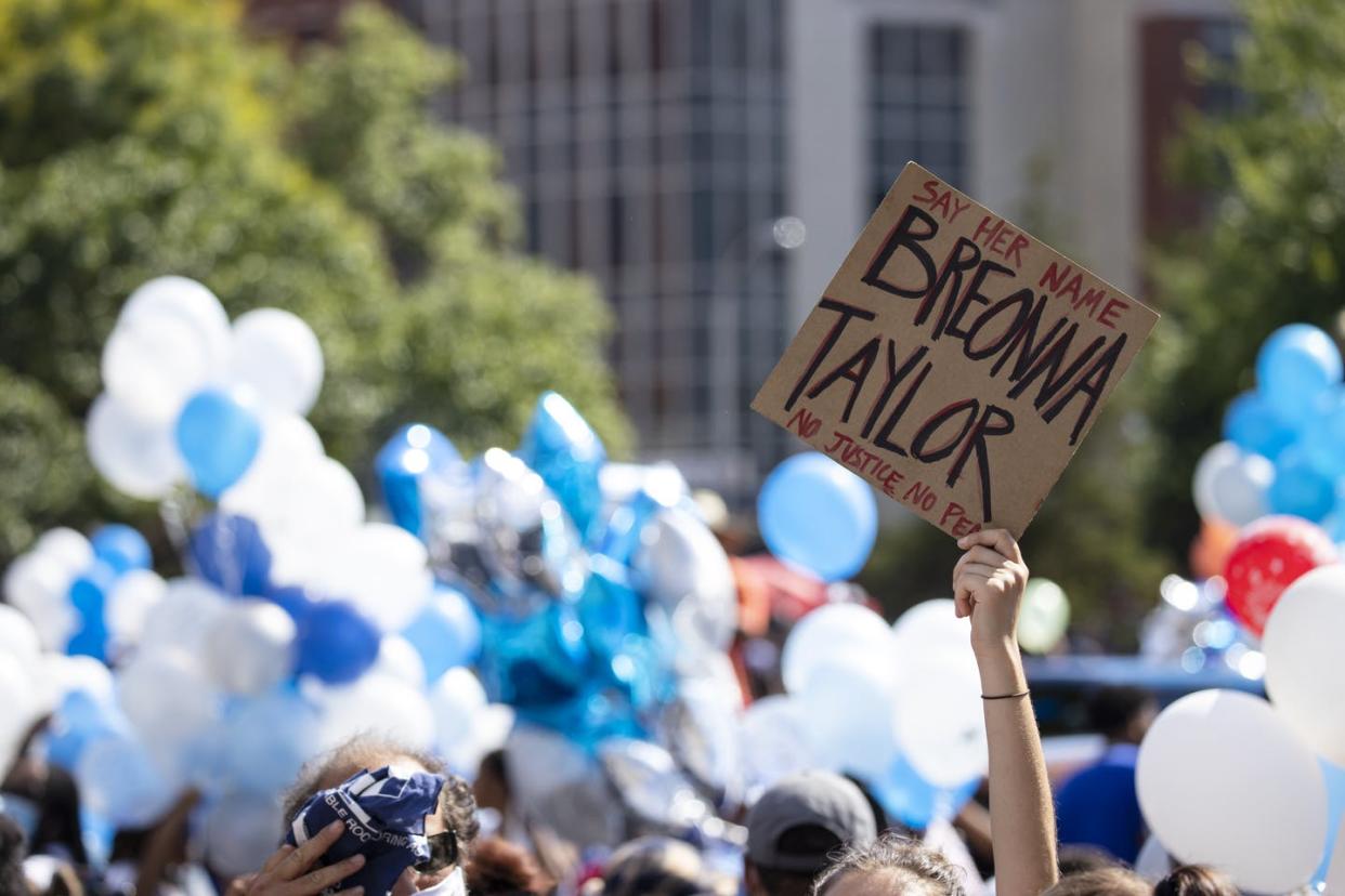 <span class="caption">A protester holds up a sign with Breonna Taylor's name. Taylor was killed by police officers on March 13.</span> <span class="attribution"><a class="link " href="https://www.gettyimages.com/detail/news-photo/people-gather-with-balloons-for-a-vigil-in-memory-of-news-photo/1218020612?adppopup=true" rel="nofollow noopener" target="_blank" data-ylk="slk:Brett Carlsen/Getty Images;elm:context_link;itc:0;sec:content-canvas">Brett Carlsen/Getty Images</a></span>