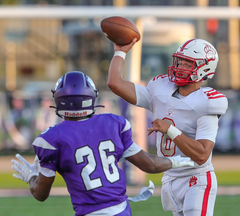 Wadsworth quarterback Luke Fischer gets off a second quarter pass in front of Barberton's Xzavier Macon on Friday, Aug. 19, 2022 in Barberton.