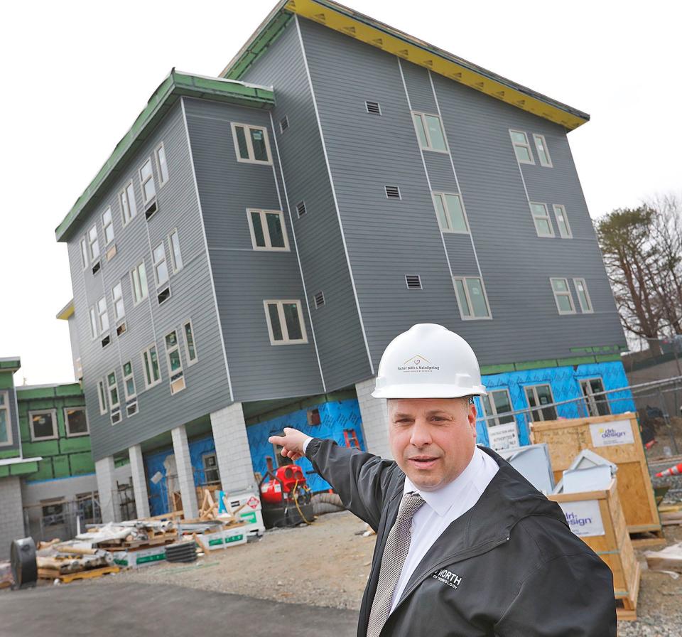 At left is the new emergency shelter for those experiencing homelessness. At right is a new building of permanent housing, shown by Father Bill's CEO John Yazwinski on Thursday, March 23, 2023.