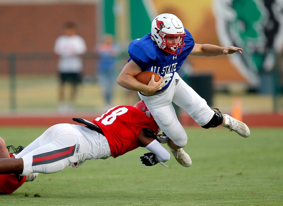 East's Andrew Carney (Collinsville) is tripped up by West's Xzavier Thomas (Carl Albert) during the Oklahoma Coaches Association All State football game at the Crain Family Stadium on the campus of Oklahoma Baptist University in Shawnee, Okla., Friday, July, 29, 2022. 