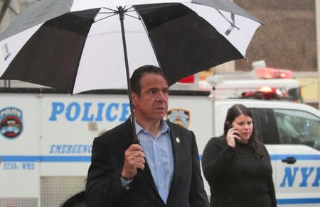 New York Governor Andrew Cuomo arrives at the scene after a helicopter crashed atop a building in New York