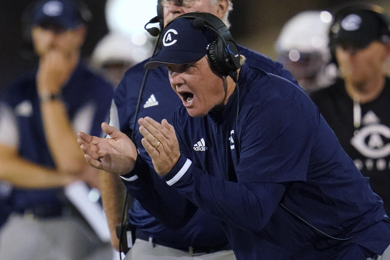 UC Davis coach Dan Hawkins applauds during the second half of the team's NCAA college football game against Tulsa, Thursday, Sept. 2, 2021, in Tulsa, Okla. (AP Photo/Sue Ogrocki)