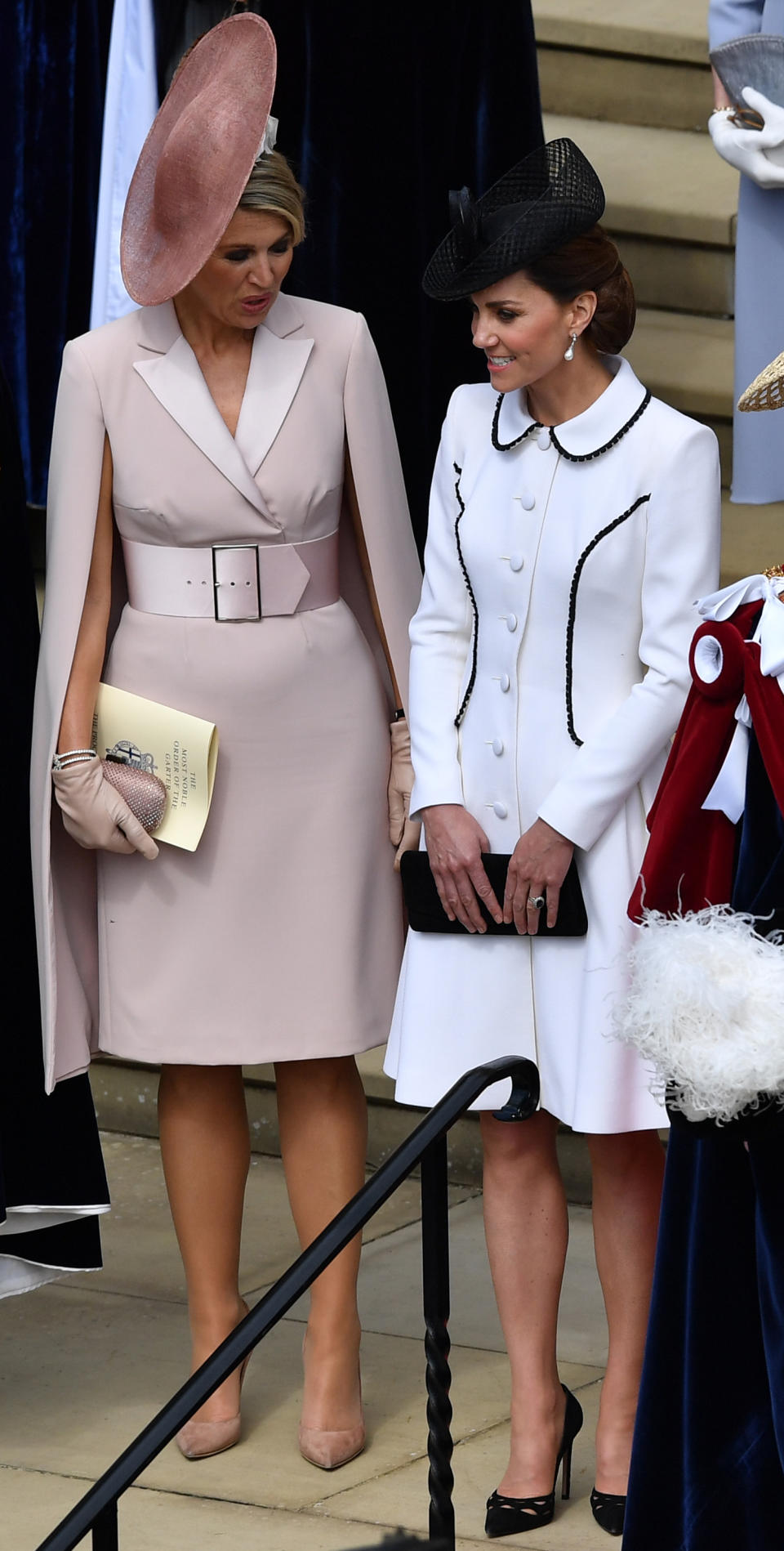 For the Order of the Garter service, Kate wore a white Catherine Walker coat dress with black piping with a Lock & Co hat, her black Prada pumps, Stuart Weitzman clutch and Princess Diana's Collingwood pearl earrings. [Photo: PA]