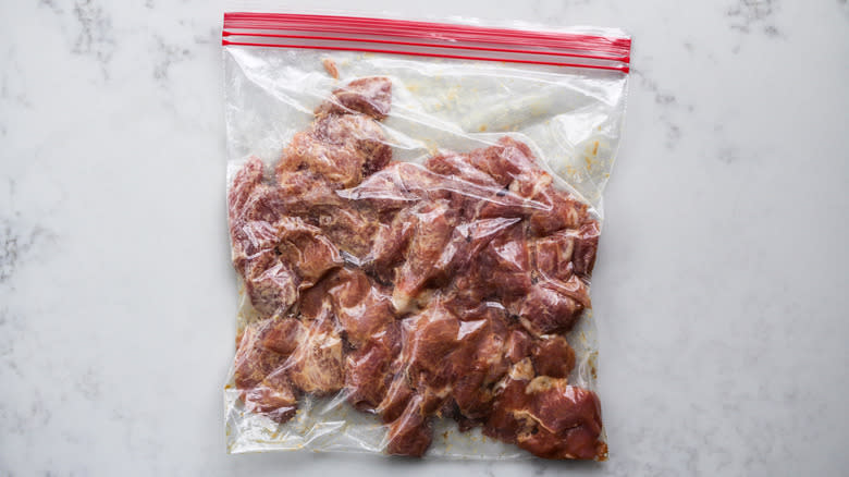 pork pieces marinating in plastic bag