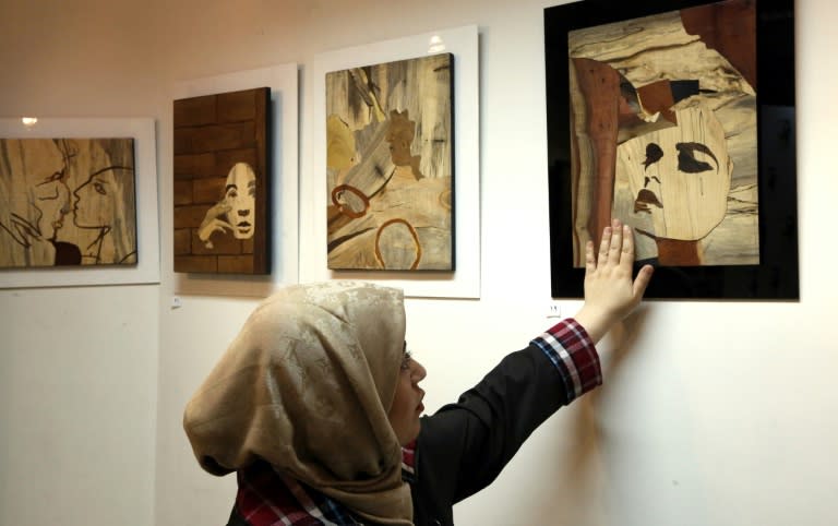 Iranian acid attack victims are presenting their work at Tehran's Ashianeh gallery, determined to be known not as victims but as artists