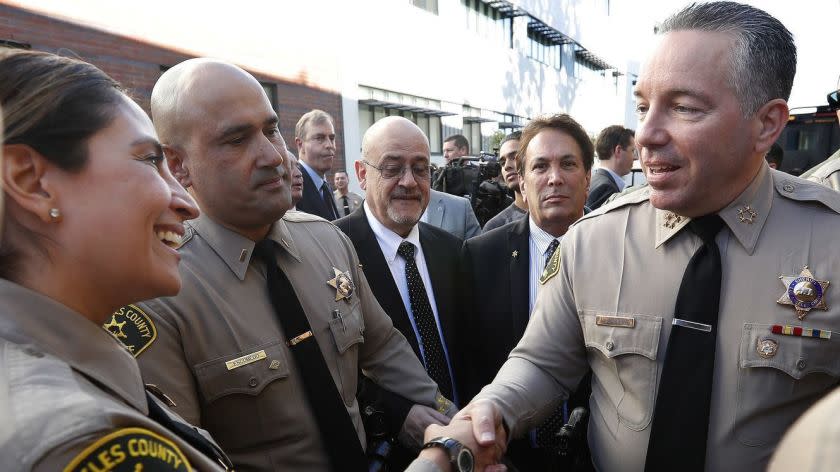 MONTEREY PARK, CA-DECEMBER 3, 2018: Alex Villanueva, right, the new Los Angeles County Sheriff, greets members of the force after his swearing in ceremony at East Los Angeles College in Monterey Park on December 3, 2018. (Mel Melcon/Los Angeles Times)