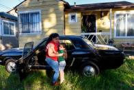 Ashley Avila, 11, with her nephew Alexander Avila, 3, outside of their home where Alexander was lead poisoned by lead-based paint in Oakland