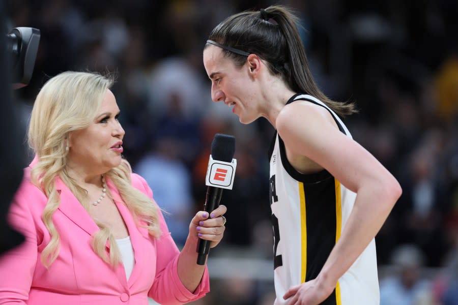 ALBANY, NEW YORK – APRIL 01: Caitlin Clark #22 of the Iowa Hawkeyes talks with ESPN’s Holly Rowe during halftime of a game against the LSU Tigers in the Elite 8 round of the NCAA Women’s Basketball Tournament at MVP Arena on April 01, 2024 in Albany, New York. (Photo by Andy Lyons/Getty Images)