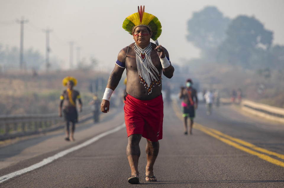 Kayapo Indigenous block a highway near Novo Progresso, Para state, Brazil, Monday, Aug. 17, 2020. Protesters blocked BR-163 to pressure Brazilian President Jair Bolsonaro to better shield them from COVID-19, to extend damages payments for road construction near their land, and to consult them on a proposed cargo railway. (AP Photo/Andre Penner)