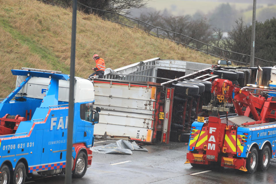 Recovery vehicles at the scene of an accident on the eastbound track of the M62 motorway between junctions 21 (Milnrow) and 22 (Ripponden), near Rochdale.