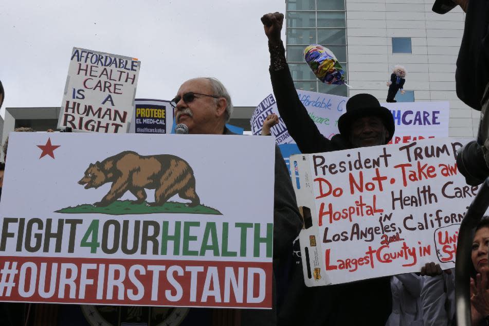 Health care workers rally to save the Affordable Care Act across the country outside LAC+USC Medical Center in Los Angeles Sunday, Jan. 15, 2017. The rally was one of many being staged across the country in advance of President-elect Donald Trump's inauguration on Jan. 20. Trump has promised to repeal and replace the health care law, and the Republican-controlled Senate on Thursday passed a measure taking the first steps to dismantle it. (AP Photo/Damian Dovarganes)