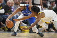 Utah Jazz guard Collin Sexton, right, and Dallas Mavericks guard Jaden Hardy (3) battle for the ball during the second half of an NBA basketball game Monday, Feb. 6, 2023, in Salt Lake City. (AP Photo/Rick Bowmer)