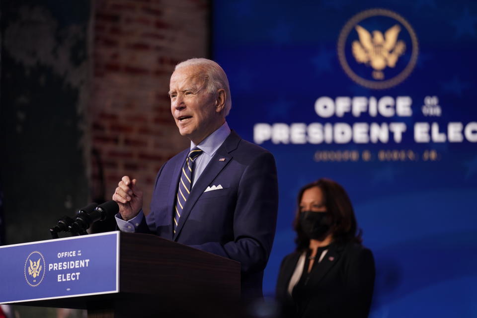 President-elect Joe Biden speaks at The Queen theater, Monday, Dec. 28, 2020, in Wilmington, Del. Vice President-elect Kamala Harris listens at right. (AP Photo/Andrew Harnik)