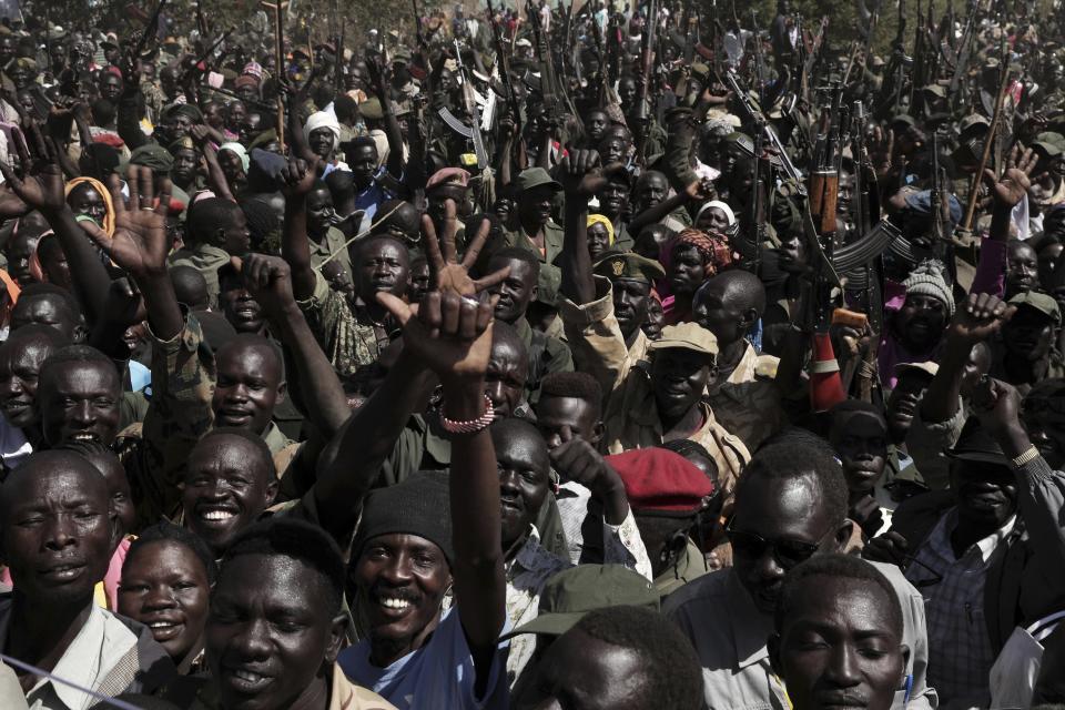 Armed rebels in support of Sudan Liberation Movement-North Leader, Adel-Aziz al-Hilu, chant slogans during a visit organized by The World Food Program (WFP) in the conflict-affected remote town of Kauda, Nuba Mountains, Sudan, Jan. 9, 2020. Sudan’s Prime Minister, Abdalla Hamdok, accompanied by United Nations officials, embarked on a peace mission Thursday to Kauda, a rebel stronghold, in a major step toward government efforts to end the country’s long-running civil conflicts. (AP Photo/Nariman El-Mofty)