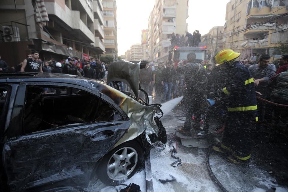 A firefighter extinguishes a fire on a car at the site of an explosion in Beirut's southern suburbs January 2, 2014. The powerful explosion struck southern Beirut on Thursday, a stronghold of the Shi'ite group Hezbollah, killing at least two people and sending a column of smoke into the sky, a witness said. (REUTERS/Hasan Shaaban)