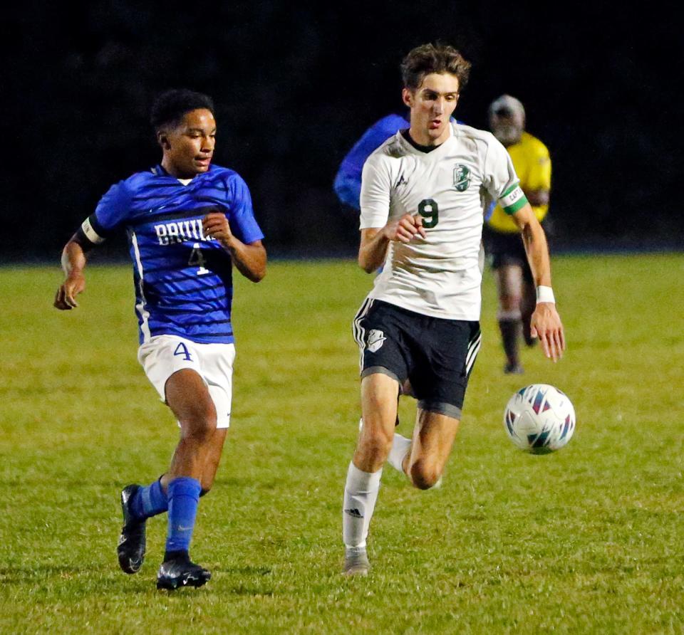 South Bend Trinity at Greenlawn senior Caleb DeLorenzo (9) and Bethany Christian senior Shemaya Magatti chase down a loose ball during a game Tuesday, Sept. 19, 2023, at Bethany Christian High School in Goshen.