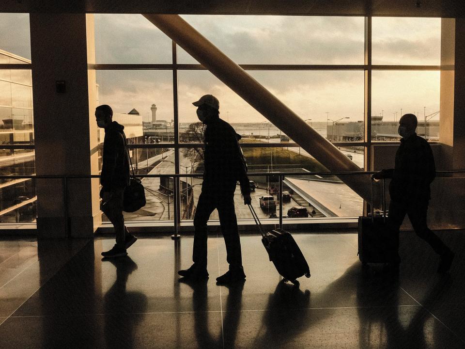 Holiday travelers walk through the Detroit Metropolitan Wayne County Airport on November 21, 2021 in Detroit, Michigan