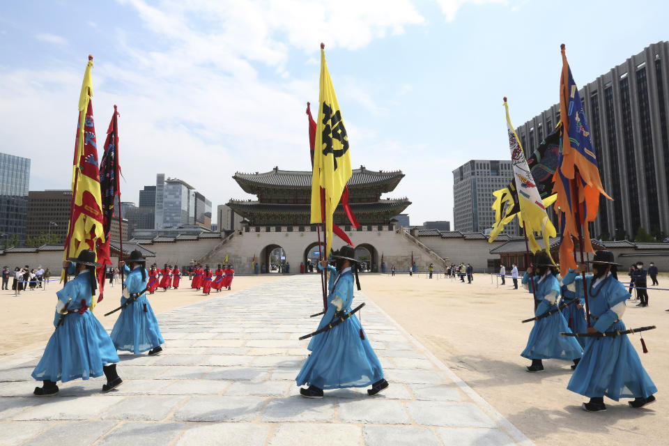 South Korean Imperial guards wearing face masks move during a reenactment of the Royal Guards Changing Ceremony, which had been suspended due to the new coronavirus, at Gyeongbok Palace in Seoul, South Korea, Thursday, May 21, 2020. (AP Photo/Ahn Young-joon)