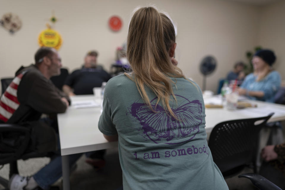 Clients and staff gather at FOCUS Recovery and Wellness Community Center in Findlay, Ohio, Friday, Oct. 20, 2023. FOCUS offers free support and resources to anyone impacted by mental health, addiction, or trauma issues. FOCUS also runs a center for teens in Hancock County. (AP Photo/Carolyn Kaster)