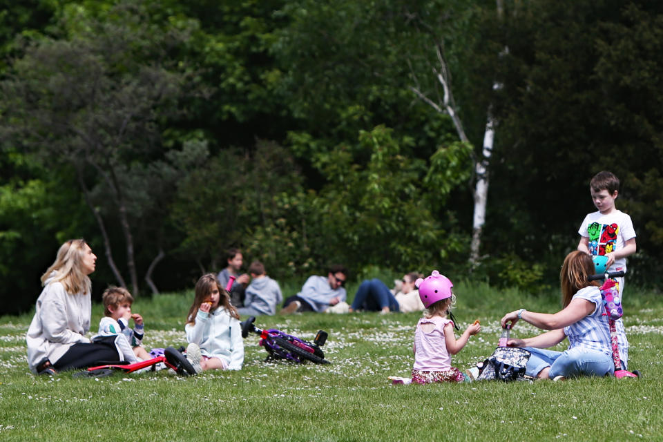 A general view of people sitting in Hove Park, near Brighton, as the UK continues in lockdown to curb the spread of Coronavirus during the pandemic.