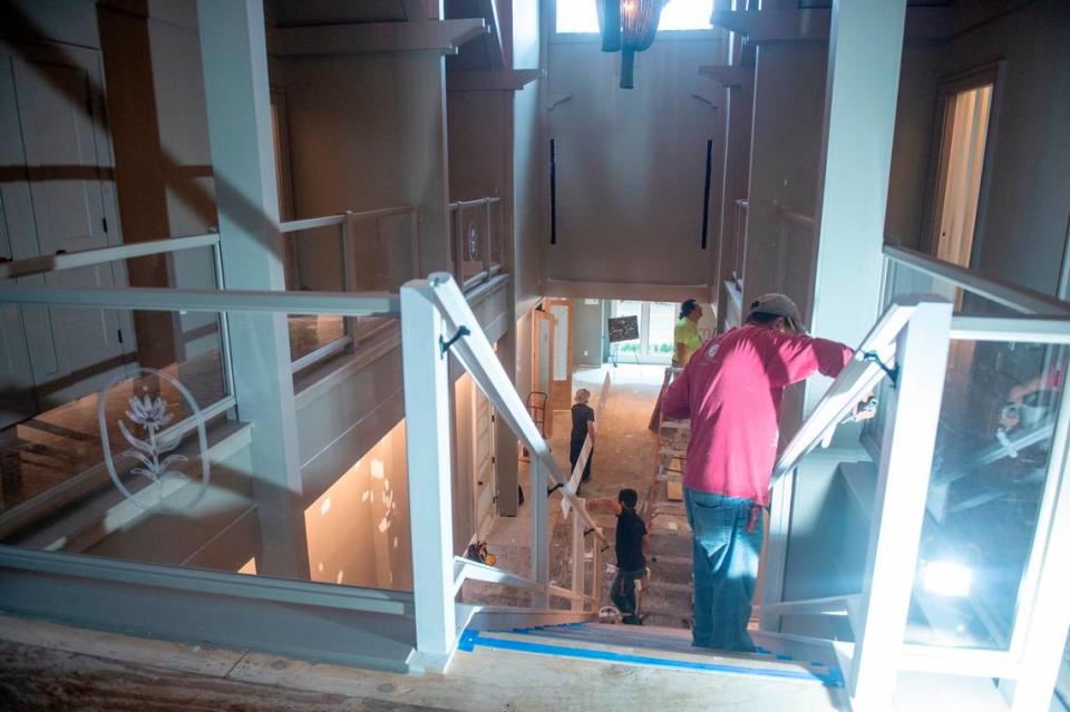 Workers work on the main stairwell of The Springs Hotel while it’s under construction in Ocean Springs on Monday, Nov. 20, 2023.