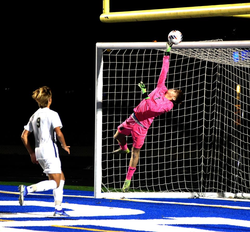 Wooster keeper Griffin Owen saves a goal as St. Ignatius' Zsombor Onodi moves in.