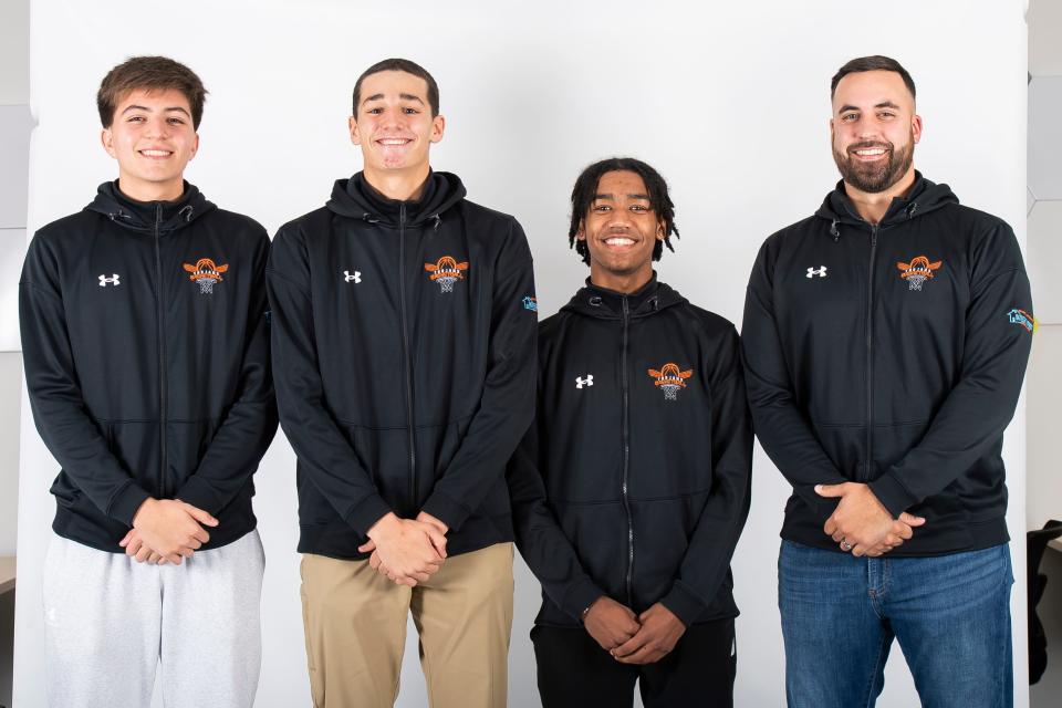 (From left) York Suburban basketball players Kai Stryhn, Luke Andricos and Mekhi Rhoades pose for a photo with head coach Mitch Kemp during YAIAA winter sports media days Wednesday, November 8, 2023, in York.
