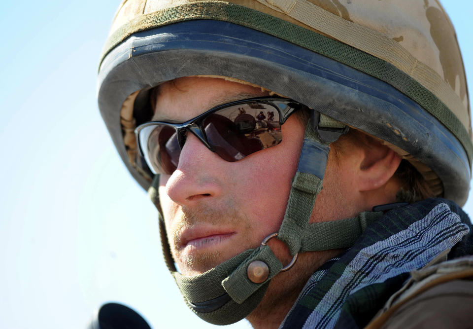 FILE - In this Feb. 18, 2008 file photo, Britain's Prince Harry, sits atop a military vehicle in the Helmand province, Southern Afghanistan. Princess Diana’s little boy the devil-may-care red-haired prince with the charming smile is about to become a father. The arrival of the first child for Prince Harry and his wife Meghan will complete the transformation of Harry from troubled teen to family man, from source of concern to source of national pride. (John Stillwell, Pool Photo via AP, File)