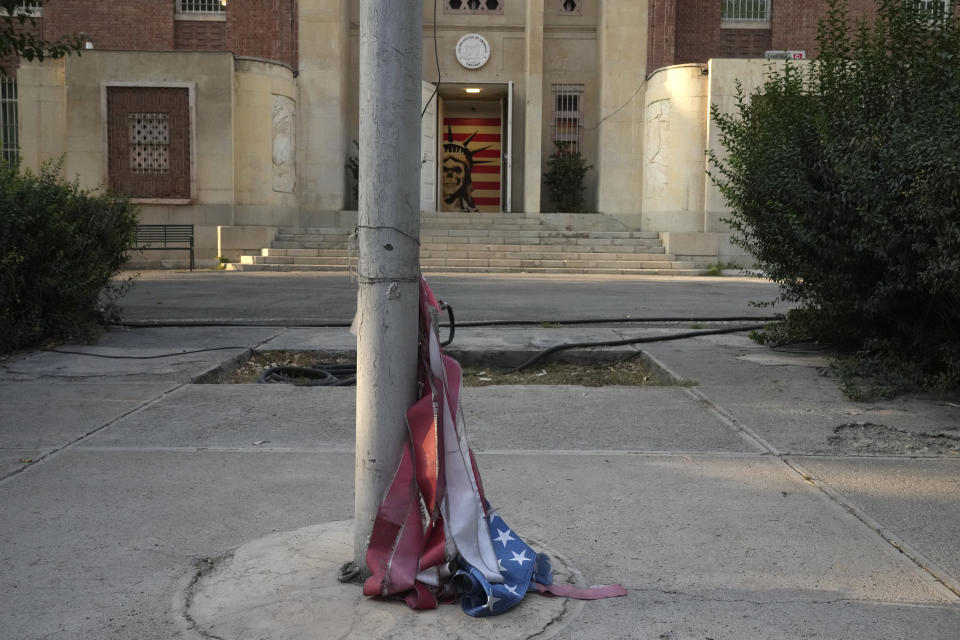 FILE - A torn U.S flag is placed under a flagpole at the former U.S. Embassy, which has been turned into an anti-American museum, in TehranIran, Saturday, Aug. 19, 2023. The upcoming prisoner swap between Iran and the United States follows the same contours that the countries have tracing since the resolution of the 1979 U.S. Embassy takeover and hostage crisis. The limits of this diplomacy remain largely the same as they have been for over the four decades since, with officials in both countries even using similar language to discuss the deals now. (AP Photo/Vahid Salemi, File)