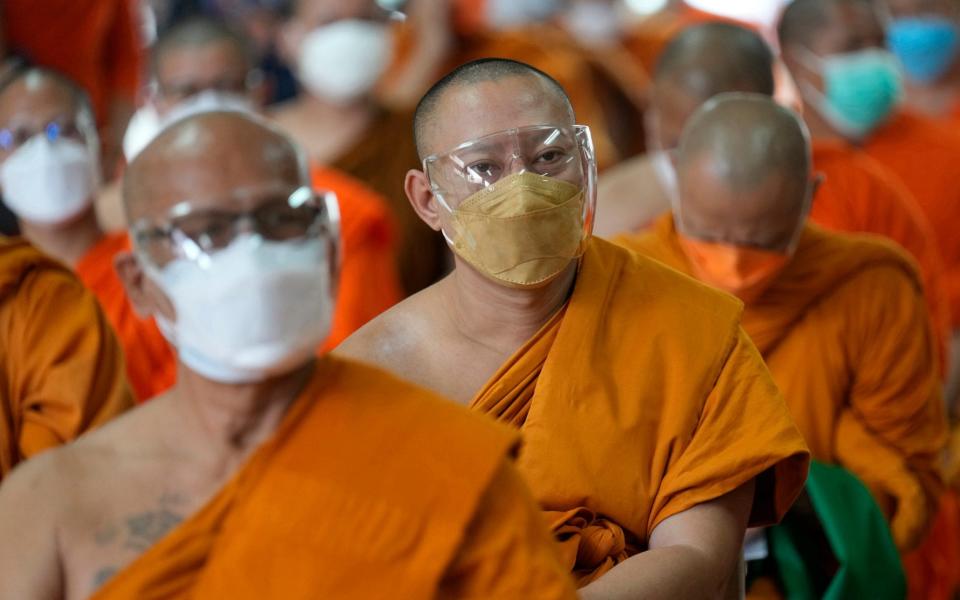 Buddhist monks wait to be vaccinated against Covid-19 in Bangkok, Thailand on 30 July 2021 - Sakchai Lalit/AP