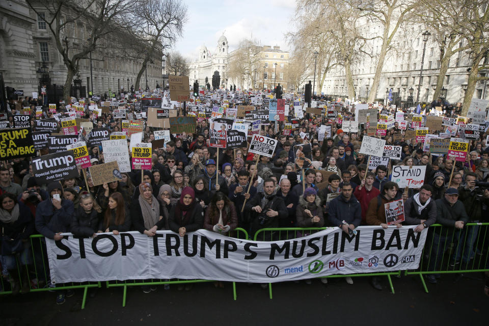 Demonstrators hold placards outside Downing Street during a march against U.S. President Donald Trump and his temporary ban on refugees and nationals from seven Muslim-majority countries from entering the United States, in London, Britain, February 4, 2017.