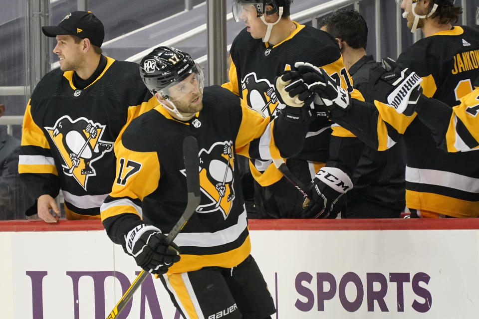 Pittsburgh Penguins' Bryan Rust (17) returns to the bench after scoring during the second period of an NHL hockey game against the New York Rangers in Pittsburgh, Sunday, Jan. 24, 2021. (AP Photo/Gene J. Puskar)