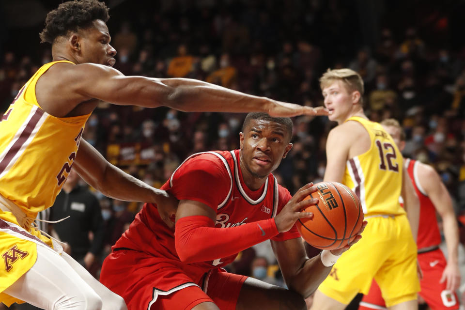 Ohio State forward E.J. Liddell, front right, looks around Minnesota forward Danny Ogele, left, in the second half of an NCAA college basketball game Thursday, Jan. 27, 2022, in Minneapolis. (AP Photo/Bruce Kluckhohn)