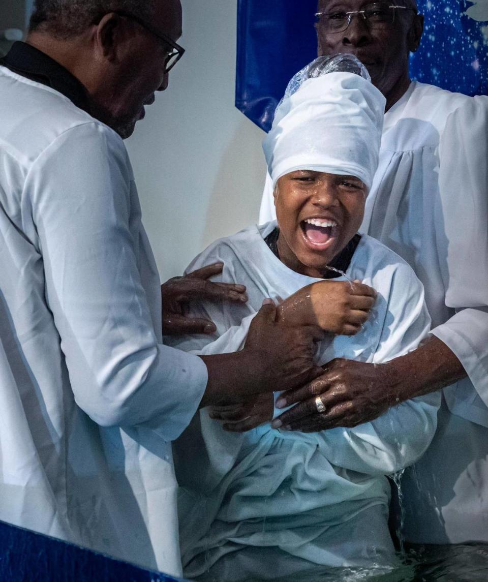 Twelve year-old Max Sanford reacts after being baptized during a Tuesday service at New Shiloh Missionary Baptist Church. Jose A. Iglesias/jiglesias@elnuevoherald.com