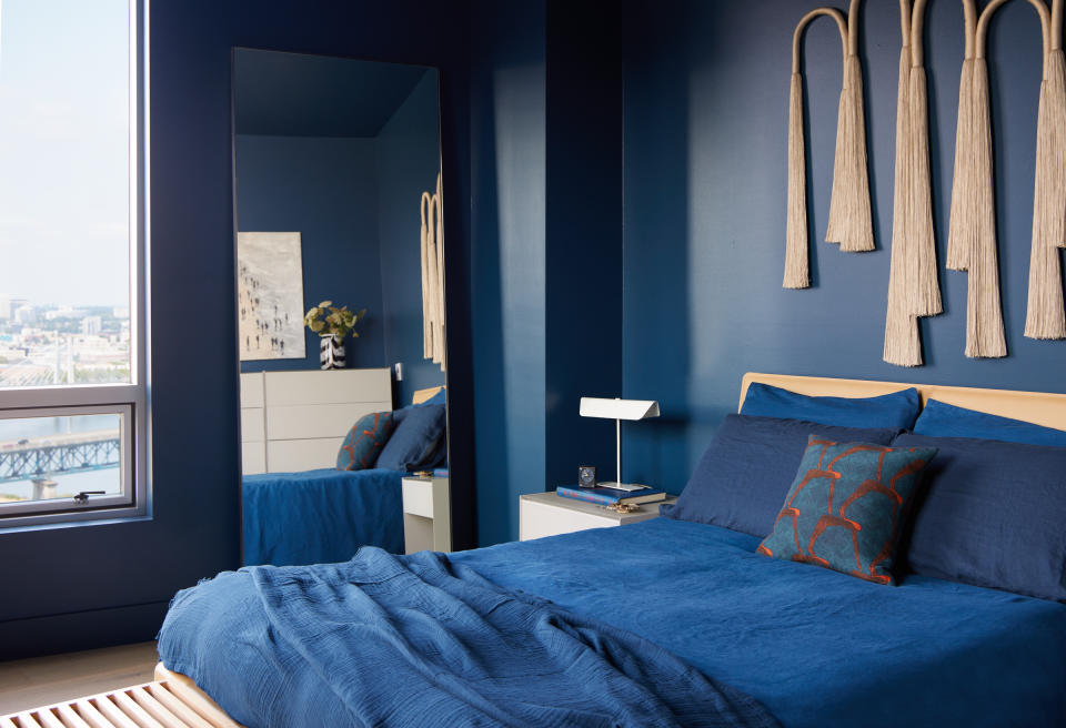 a blue bedroom with blue walls