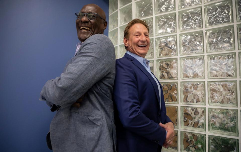 Luther Bradley, a former first-round draft pick of the Detroit Lions in 1978, who is currently a Blue Cross Blue Shield of Michigan (BCBSM) consultant, stands next to Gary Gavin, a vice president at BCBSM, inside the Blue Cross Blue Shield of Michigan headquarters in Detroit on Tuesday, April 25. Bradley has worked with Gavin for more than 20 years.
