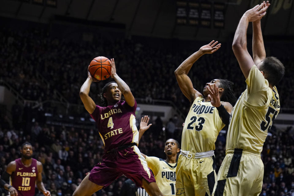 Florida State guard Caleb Mills (4) shoots over Purdue guard Jaden Ivey (23) and guard Sasha Stefanovic (55) during the first half of an NCAA college basketball game in West Lafayette, Ind., Tuesday, Nov. 30, 2021. (AP Photo/Michael Conroy)